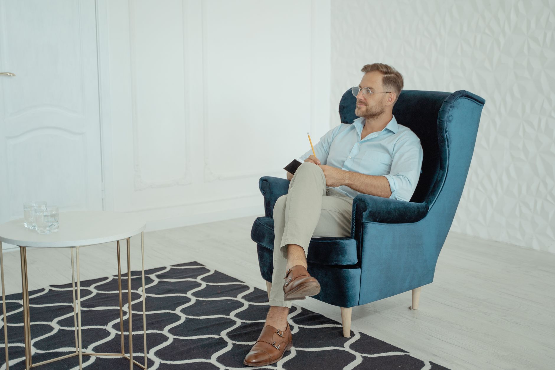 A man sitting in an armchair in a consulting room