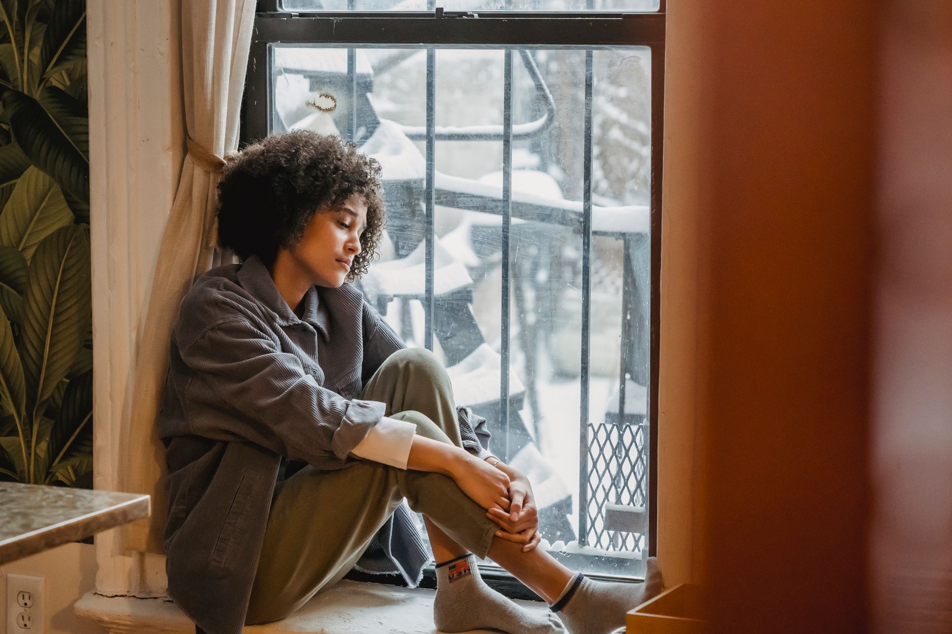 A person sitting quietly by a window