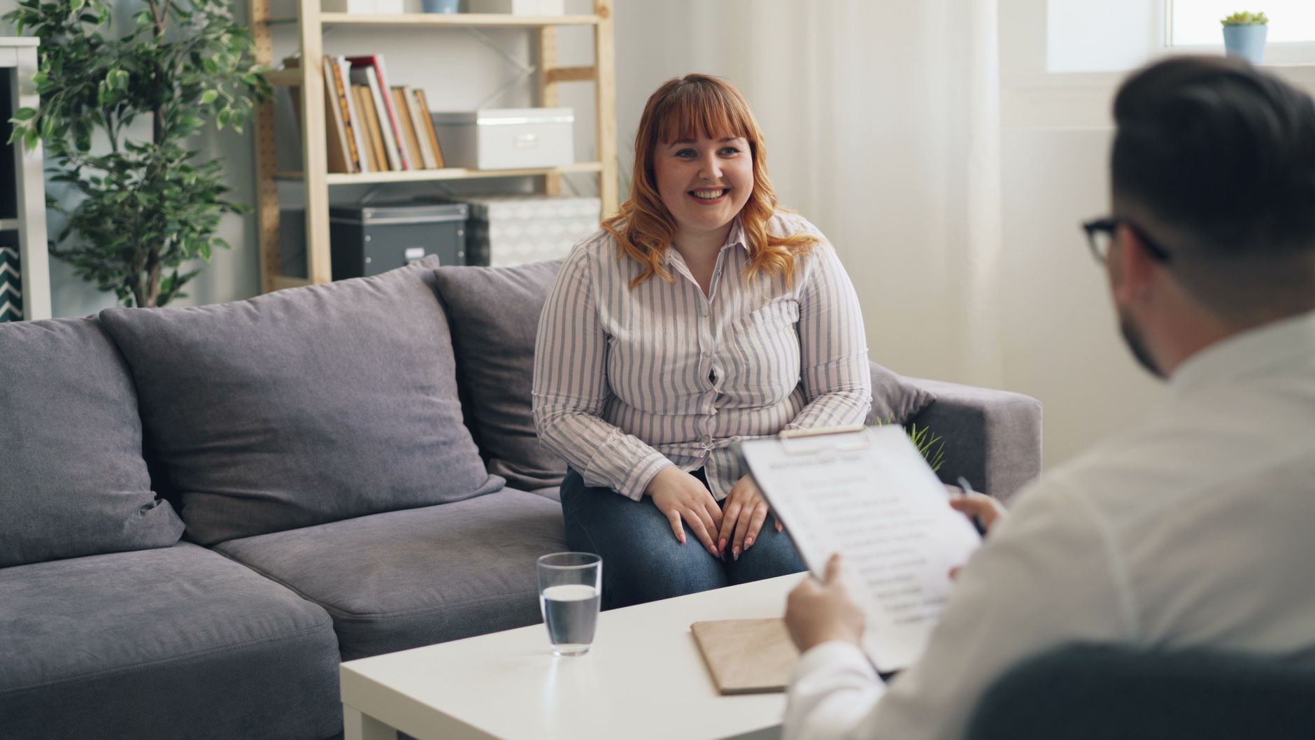 A young woman talking with a clinician during a session
